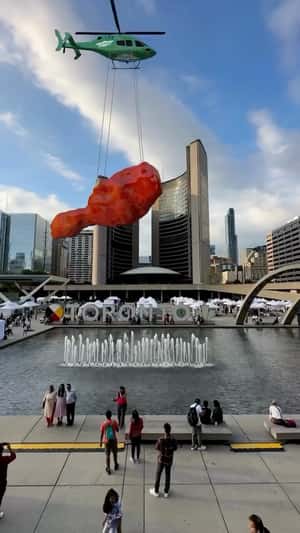 Giant Fried Chicken Airlifted Over City in a fake-out-of-home ad of Wingstop