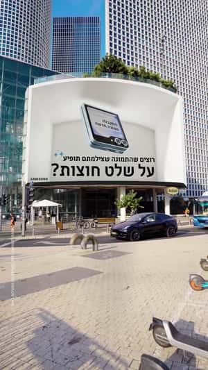 Giant Flip Phone Emerges from Billboard in a fake-out-of-home ad of Samsung