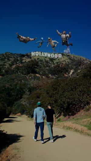 Characters Float Above Hollywood Sign in a fake-out-of-home ad of Fortnite