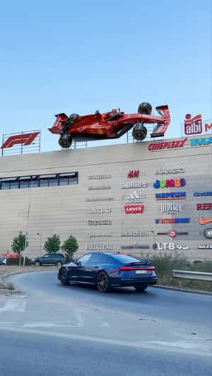 Giant F1 Ferrari Mounted on Albi Mall in a fake-out-of-home ad of Cineplexx
