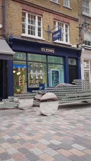 F1 Race Car of Jars Ride Through Street in fake-out-of-home ad of Elemis 