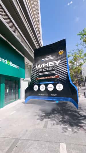 Whey Protein Spacecraft Lands on Storefront in a fake-out-of-home ad of Holland & Barrett