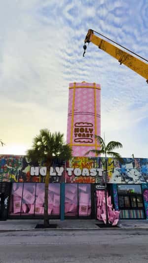 Giant Wrap Hanging from Crane in a fake-out-of-home ad of Holy Toast