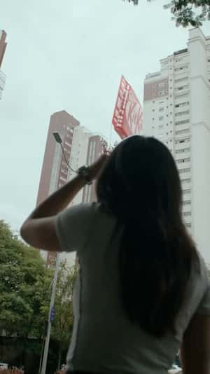 Woman Grabs Massive Bar in a fake-out-of-home ad of KitKat