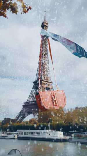 Giant Bag Hangs on the Eiffel Tower in a fake-out-of-home ad of Lancel