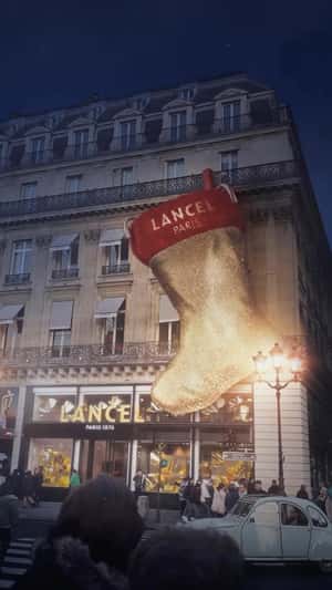 Santa Puts Bags into Giant Christmas Sock in a fake-out-of-home ad of Lancel