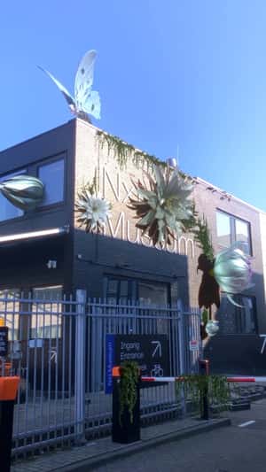 Giant Flowers Bloom on Building Facade in a fake-out-of-home ad of Nxt Museum