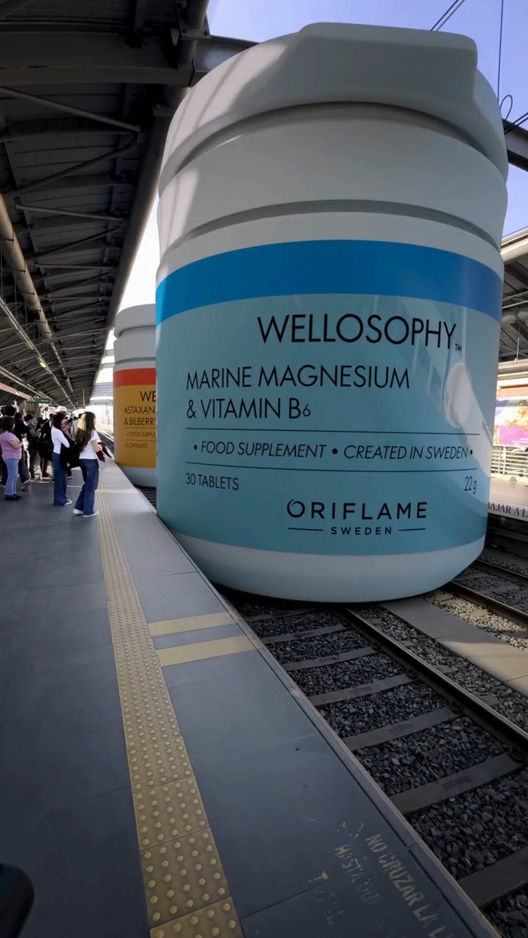 Giant Bottles Glide on Train Tracks in a fake-out-of-home ad of Oriflame
