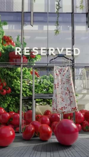 Giant Tomatoes Roll Out of Greenhouse in a fake-out-of-home ad of Reserved 