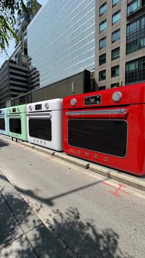 Giant Ovens Move Like a Train in a in a fake-out-of-home ad of Smeg