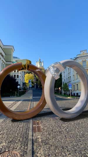 Giant Rings Roll Through Kyiv Streets in a fake-out-of-home ad of Sova