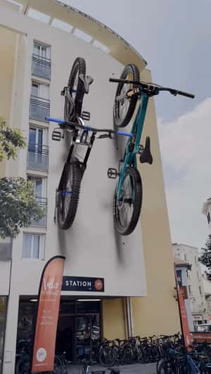 Bikes Suspended on Facade in a fake-out-of-home ad of Velo Station 
