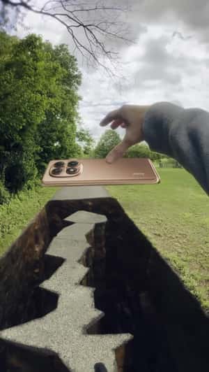Giant Phone Bridges Park Path in a fake-out-of-home ad of Xiaomi 