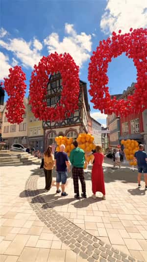 Red Balloons Form "100" in a fake-out-of-home ad of Xiaomi
