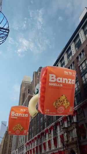 Giant Packages Float in Holiday Parade in a fake-out-of-home ad of Banza 