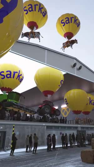 Cows and Tractors Carried by Hot Air Balloons in a fake-out-of-home ad of Sarkamessut