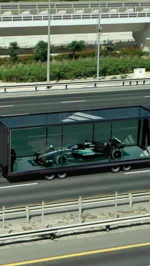 Race Car Rides Car Carrier on Highway in a fake-out-of-home ad of Adidas