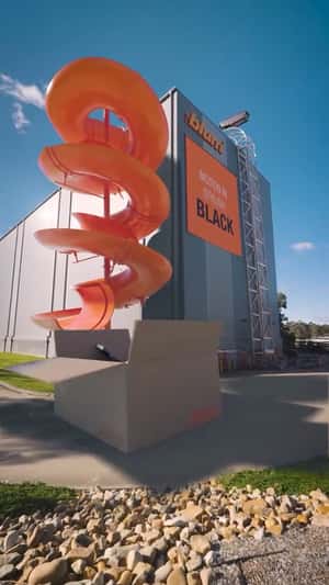 Giant Spiral Slide Outside Warehouse in a fake-out-of-home ad of Blum