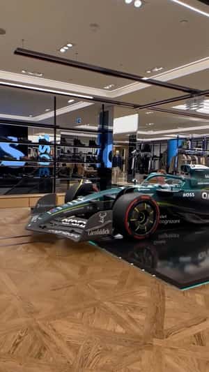 F1 Car Assembles in Store in a fake-out-of-home ad of BOSS 