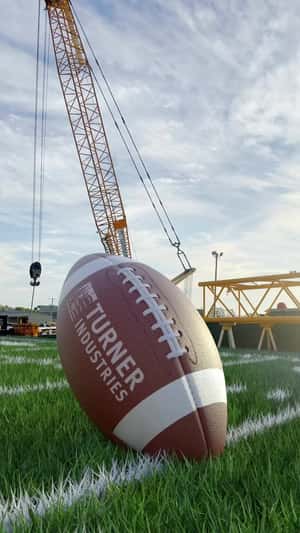 Crane Kicks Giant Football in a fake-out-of-home ad of Turner Industries 
