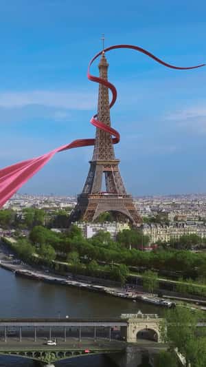 Red Ribbon Weaves Through Paris in a fake-out-of-home ad of Flamboyant Shopping 