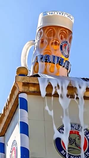 Giant Beer Mug Overflows Atop Building in a fake-out-of-home ad of Paulaner