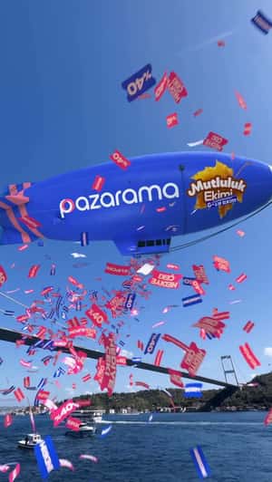 Giant Blimp Showers Tickets in a fake-out-of-home ad of Pazarama