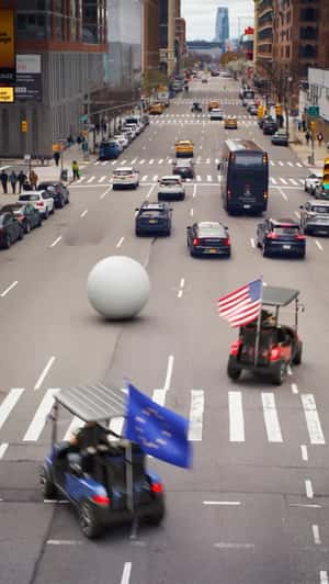 Giant Golf Ball Rolls Through Street in a fake-out-of-home ad of Ryder Cup