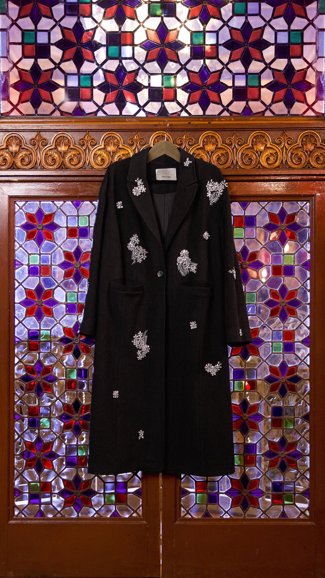 Black Clothes Hang on Rotating Christmas Tree in a fake-out-of-home ad of Cinq à Sept