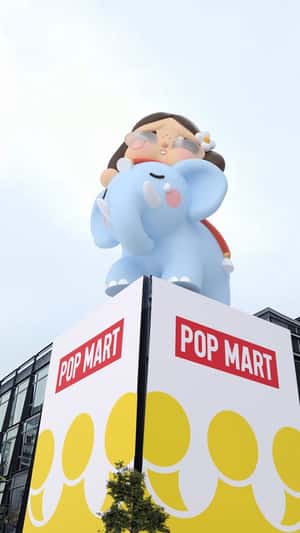 Giant Crybaby Elephant Waves at Camera in a fake-out-of-home ad of POP MART 