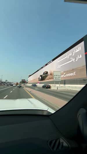 Cars Kick Up Sand From Billboard in a fake-out-of-home ad of Nissan 