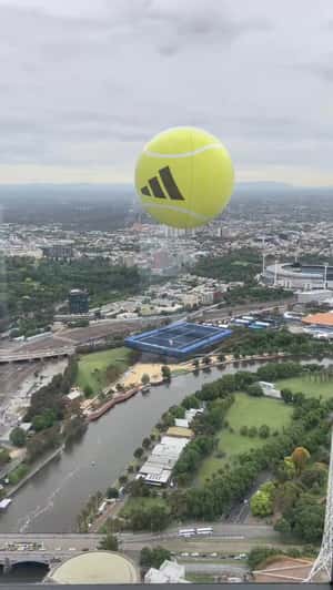 Giant Tennis Ball Airlifts Tennis Court in a fake-out-of-home ad of Adidas 
