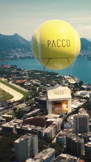 Giant Tennis Ball Carries Store in a fake-out-of-home ad of Pacco