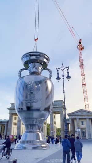 Trophy Carried by Crane in fake-out-of-home ad of Euro 2024