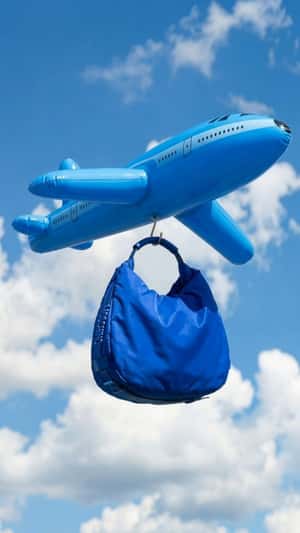 Giant Bag Hooked on Plane in a fake-out-of-home ad of Moschino