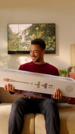 Vacuum Box Lands on Man's Arms in a fake-out-of-home ad of Dyson