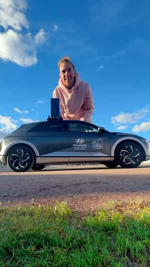 Giant Man Leaps and Shrinks Beside Car in a fake-out-of-home ad of Hyundai