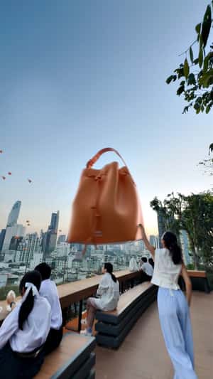 Floating Bucket Bags Over City in a fake-out-of-home ad of Bimba y Lola