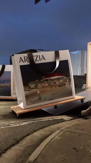 Giant Shopping Bags Roll Across Street in a fake-out-of-home ad of Aritzia