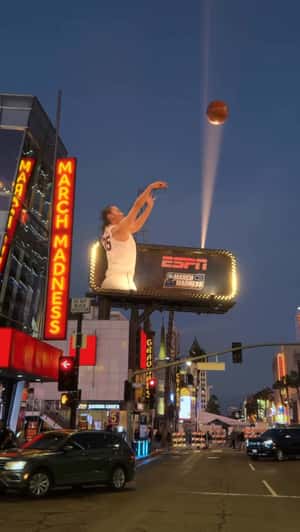 Azzi Fudd Shooting Giant Basketballs in a fake-out-of-home ad of espnW