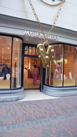 Golden Heart Necklace Hanging in fake-out-of-home ad of My Jewellery