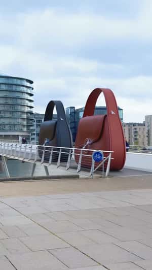 Giant Hero Bags Slide on Bryggebroen in a fake-out-of-home ad of Samsøe Samsøe