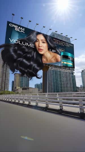L’Officiel Model's Hair Flows Out of Billboard in a fake-out-of-home ad of L'Officiel