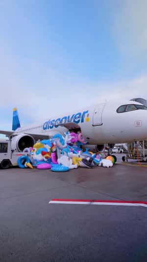 Floaties Spill on Airport Tarmac in a fake-out-of-home ad of Discover Airlines