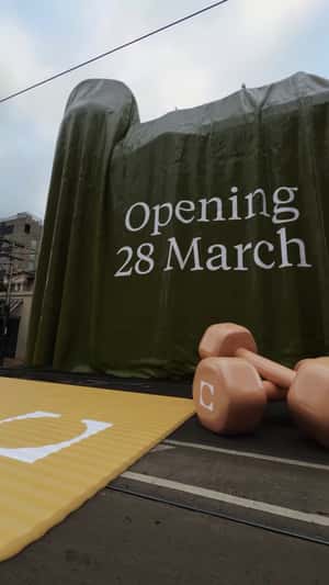 Giant Gym Props in a fake-out-of-home ad of The Commons Health Club