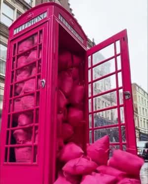 Telephone Booth Overflows with Tote Bags in a fake-out-of-home ad of Garage