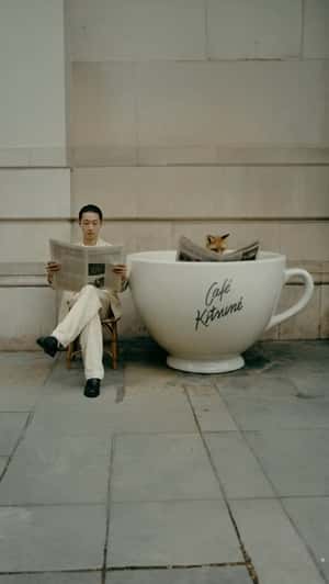 Fox Sits on Giant Coffee Cup in a fake-out-of-home ad of Maison Kitsuné