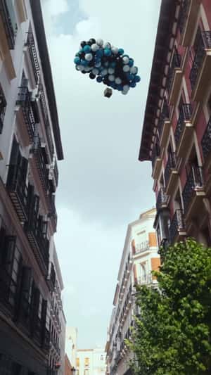 Balloons Airlifts Box Over City in a fake-out-of-home ad of Liga F