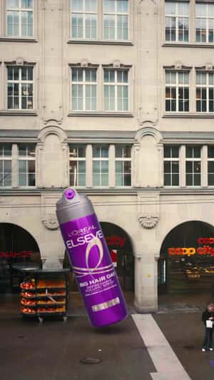 Giant Bottle Inflates at Coop City in a fake-out-of-home ad of L'Oréal Paris