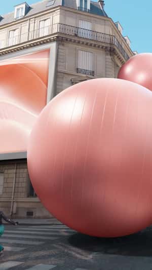 Giant Pink Sphere Bursts Out of Billboard in a fake-out-of-home ad of Biotherm